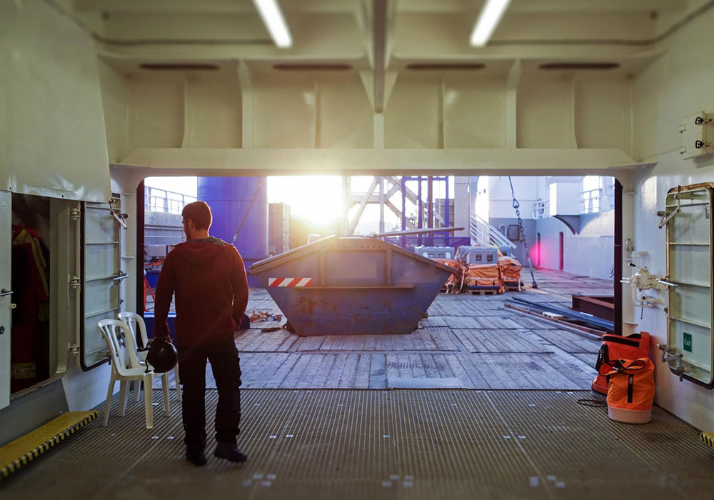 Man Using Measuring Tape in Factory Setting Man Using Measuring Tape in Factory Setting